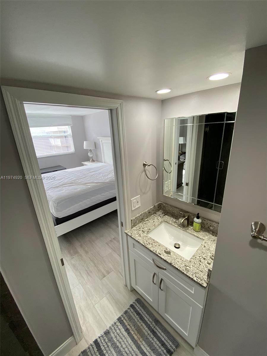 2929 South Ocean Boulevard, Unit 5090 Boca Raton, FL 33432 - Photo 13 of 25 a bathroom with a sink and a mirror