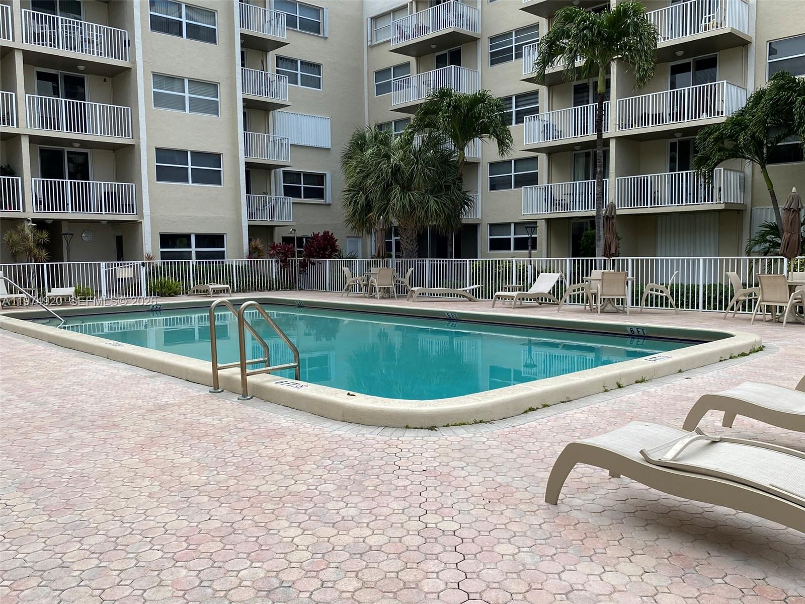 2929 South Ocean Boulevard, Unit 5090 Boca Raton, FL 33432 - Photo 21 of 25 a view of a swimming pool with a lounge chairs