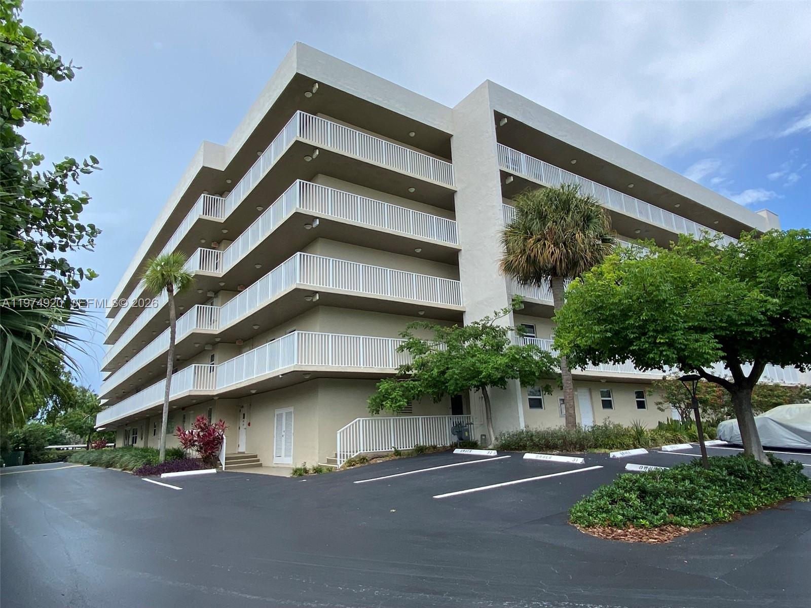 2929 South Ocean Boulevard, Unit 5090 Boca Raton, FL 33432 - Photo 25 of 25 a tall building with potted plants in front of it