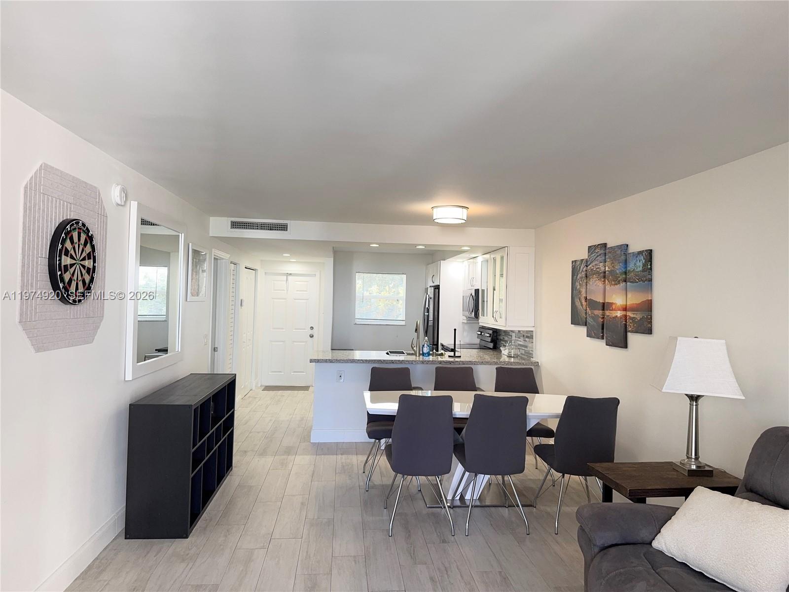 2929 South Ocean Boulevard, Unit 5090 Boca Raton, FL 33432 - Photo 6 of 25 a large kitchen with a table and chairs