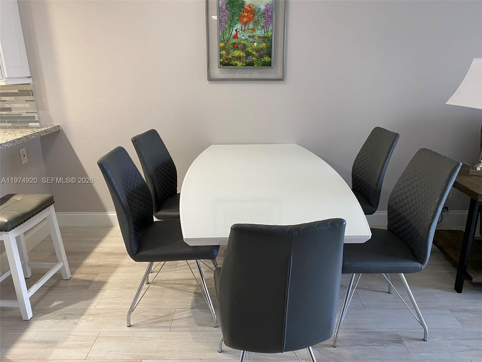 2929 South Ocean Boulevard, Unit 5090 Boca Raton, FL 33432 - Photo 7 of 25 a view of a dining room with furniture and wooden floor