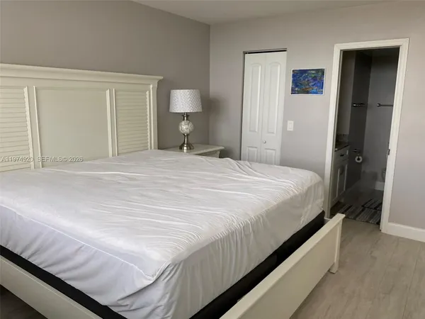 a bedroom with a bed and closet