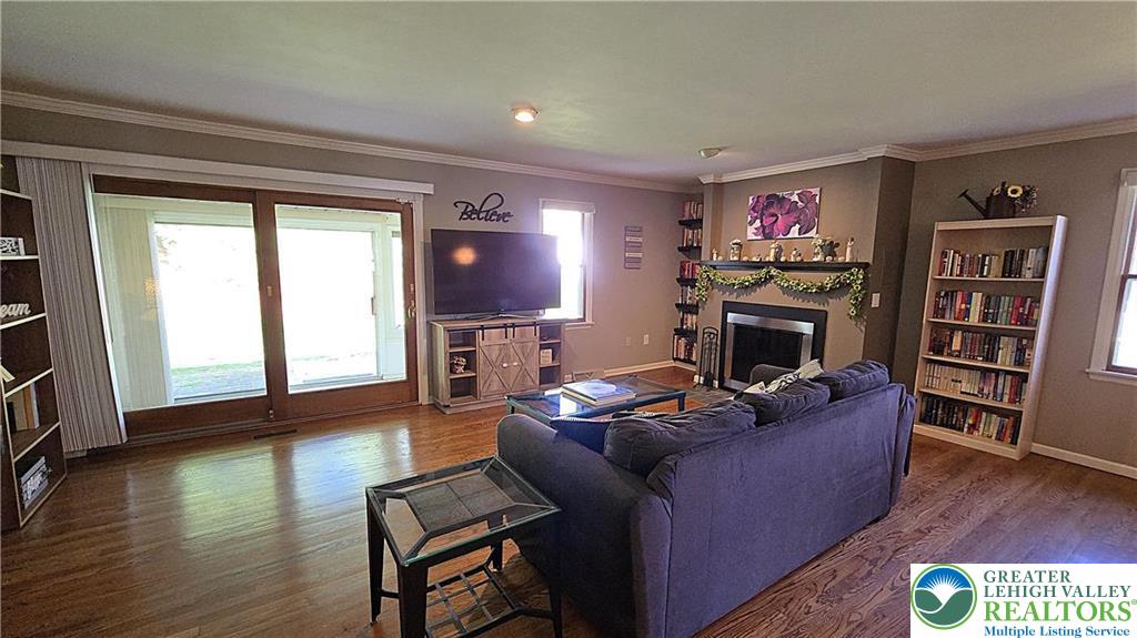 194 Springhouse Road Allentown, PA 18104 - Photo 5 of 34 This inviting living room features gleaming hardwood floors and a cozy fireplace, ideal for relaxing evenings.