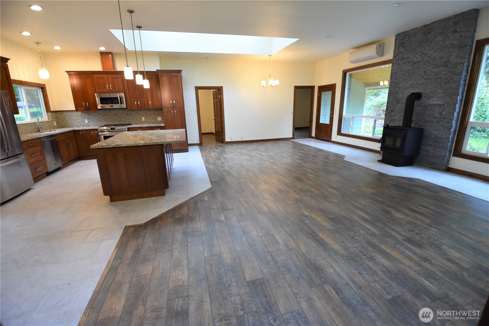 30331 Heimer Road Arlington, WA 98223 - Photo 18 of 37 a large kitchen with stainless steel appliances granite countertop a stove a refrigerator a sink dishwasher with wooden floor and dining table