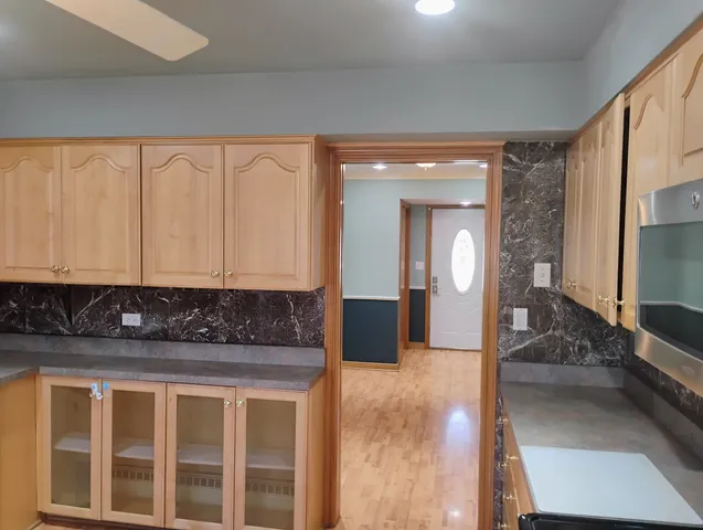 a view of a hallway with a couch and chandelier