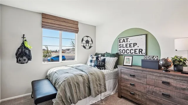 a bedroom with a bed and a painting on the wall