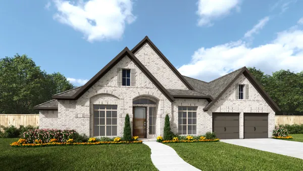 a front view of a house with a garden and yard