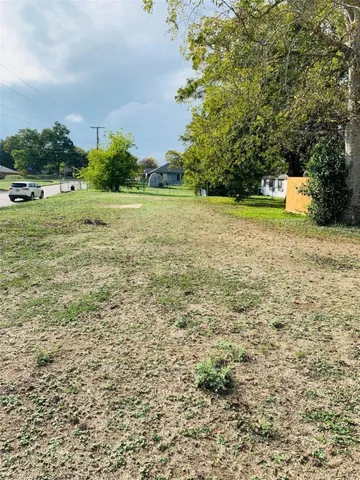 a view of a field with an trees