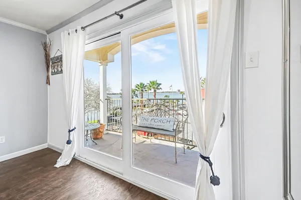 a view of front door and porch with wooden floor