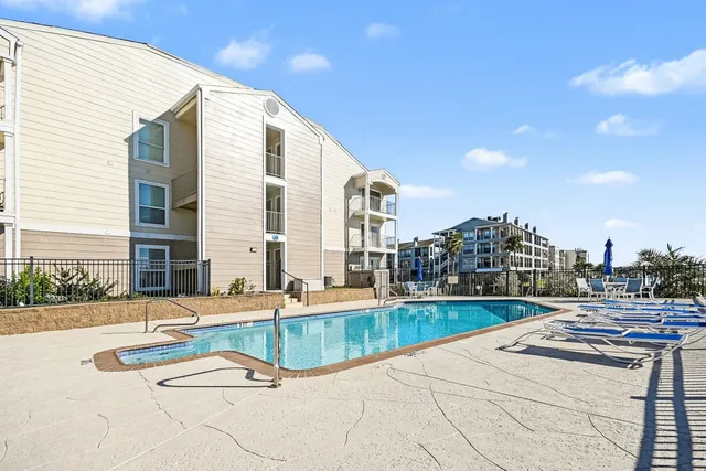 a swimming pool with outdoor seating and yard