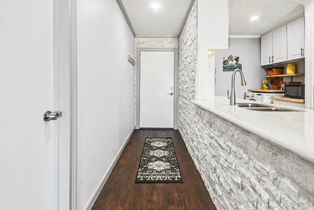 a kitchen with stainless steel appliances kitchen island granite countertop a stove and a refrigerator