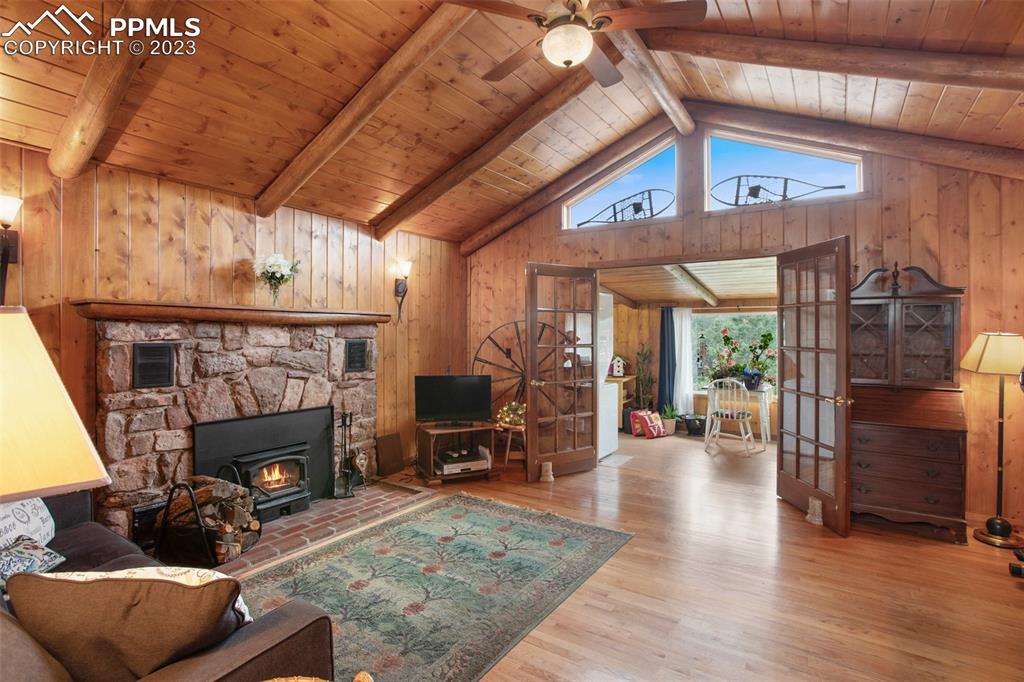 321 Dewell Road Woodland Park, CO 80863 - Photo 11 of 32 a living room with furniture and a fireplace