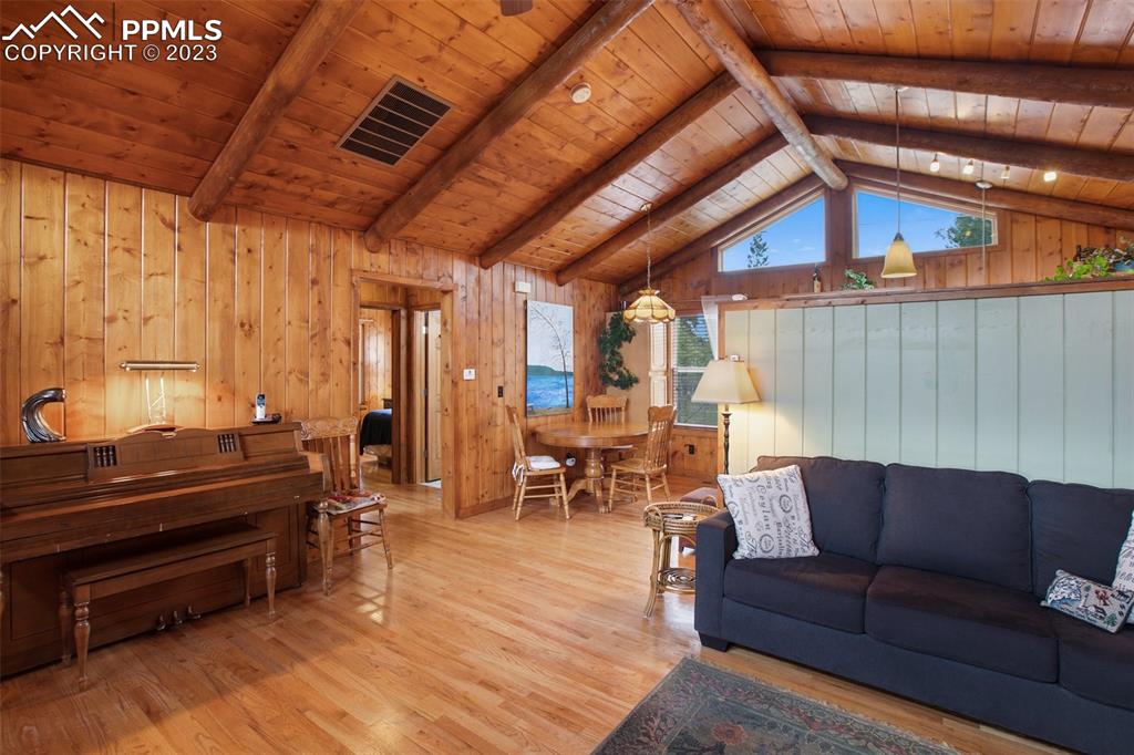 321 Dewell Road Woodland Park, CO 80863 - Photo 13 of 32 a living room with furniture and a piano