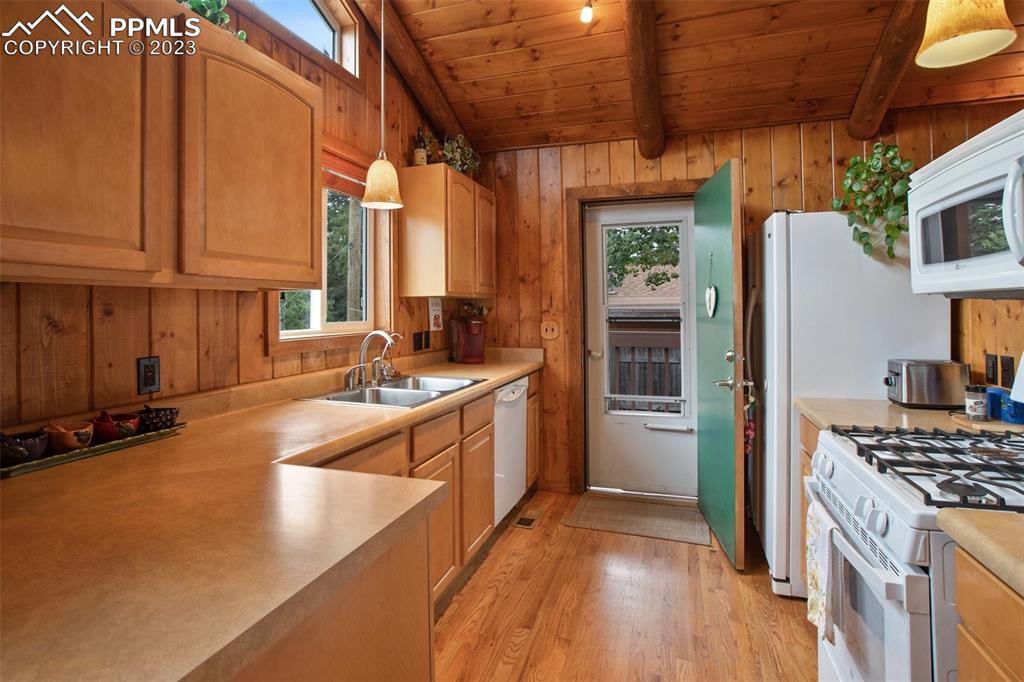 321 Dewell Road Woodland Park, CO 80863 - Photo 15 of 32 a kitchen that has a lot of cabinets in it and wooden floor