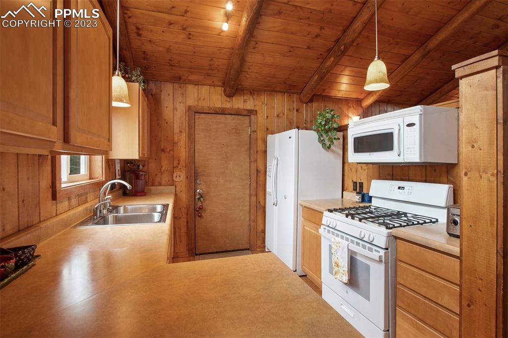 321 Dewell Road Woodland Park, CO 80863 - Photo 17 of 32 a kitchen with stainless steel appliances granite countertop a refrigerator and a stove top oven