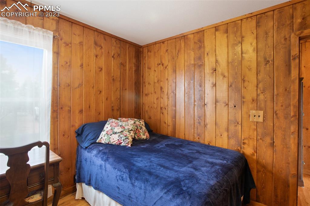 321 Dewell Road Woodland Park, CO 80863 - Photo 25 of 32 a bedroom with a bed and curtain