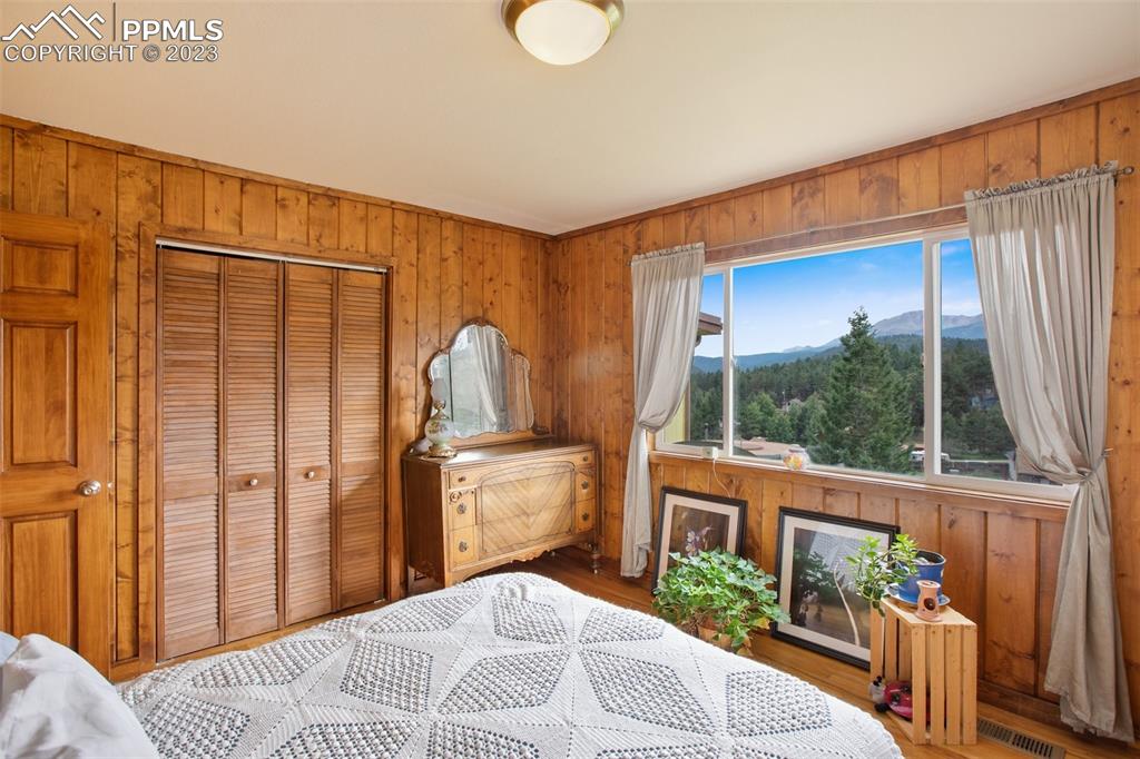 321 Dewell Road Woodland Park, CO 80863 - Photo 26 of 32 a bedroom with a bed and a large window