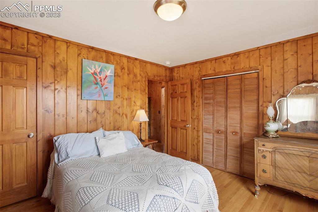 321 Dewell Road Woodland Park, CO 80863 - Photo 27 of 32 a bedroom with a bed and cabinets