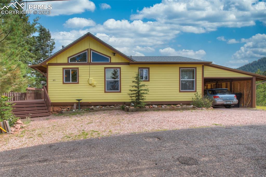 321 Dewell Road Woodland Park, CO 80863 - Photo 3 of 32 a front view of a house with a yard