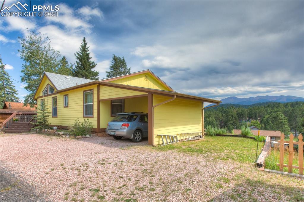 321 Dewell Road Woodland Park, CO 80863 - Photo 4 of 32 a view of a house with backyard and garden