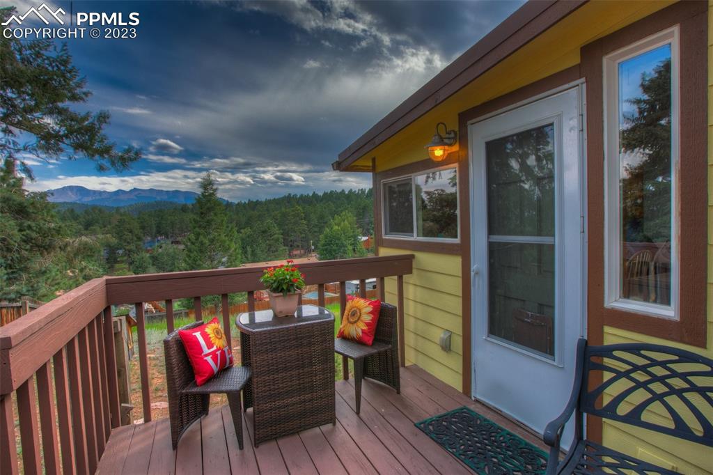 321 Dewell Road Woodland Park, CO 80863 - Photo 5 of 32 a view of a balcony with wooden floor and outdoor seating