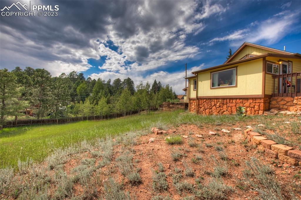 321 Dewell Road Woodland Park, CO 80863 - Photo 7 of 32 a front view of a house with a yard