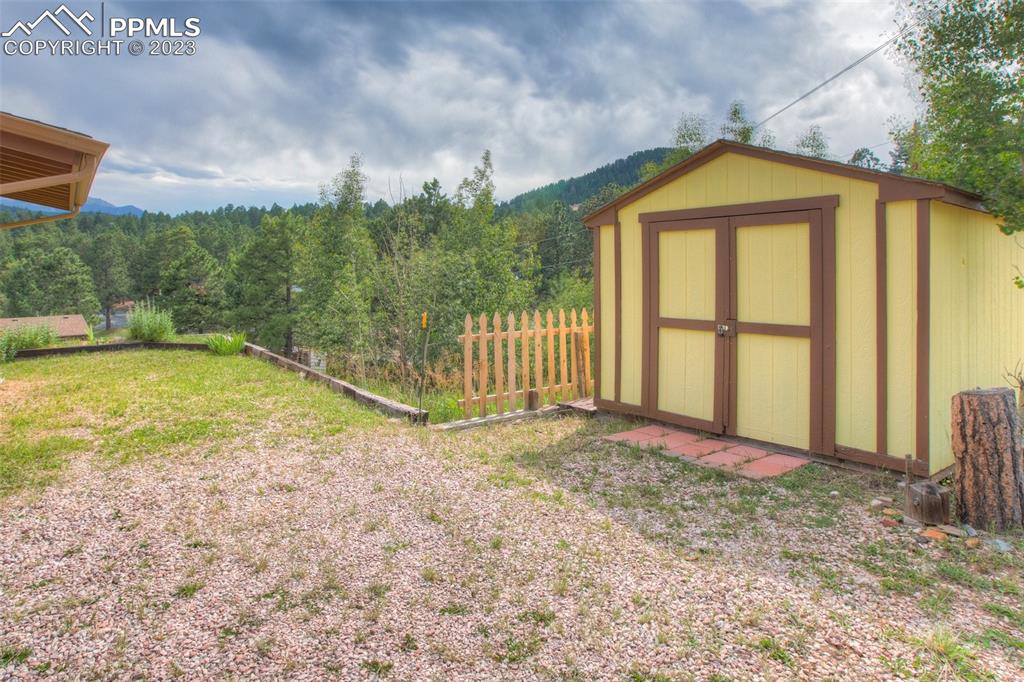 321 Dewell Road Woodland Park, CO 80863 - Photo 9 of 32 a view of a house with a yard