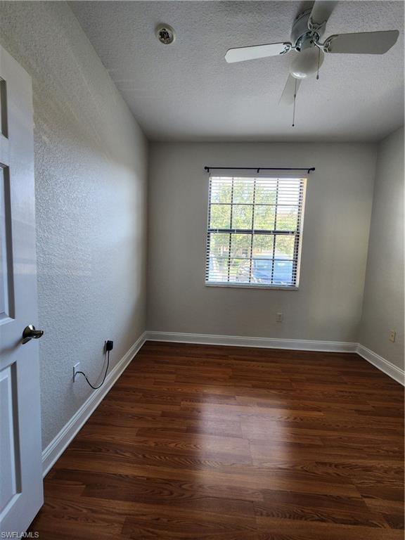 7512 Bristol Circle Naples, FL 34120 - Photo 13 of 22 wooden floor in an empty room with a window
