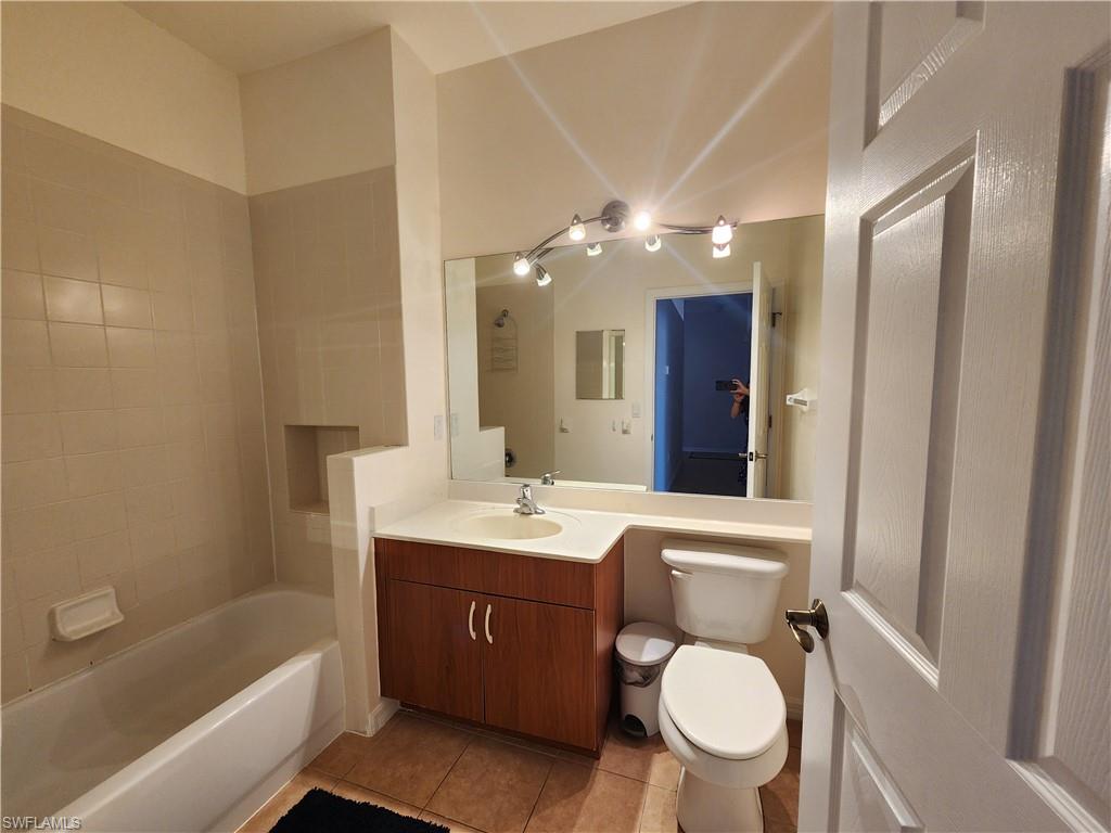 7512 Bristol Circle Naples, FL 34120 - Photo 14 of 22 a bathroom with a toilet sink and mirror