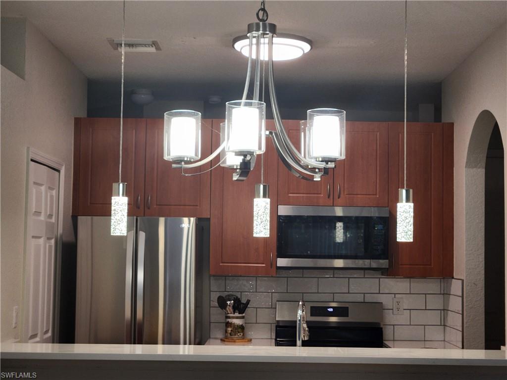 7512 Bristol Circle Naples, FL 34120 - Photo 6 of 22 a front view of a house with entryway