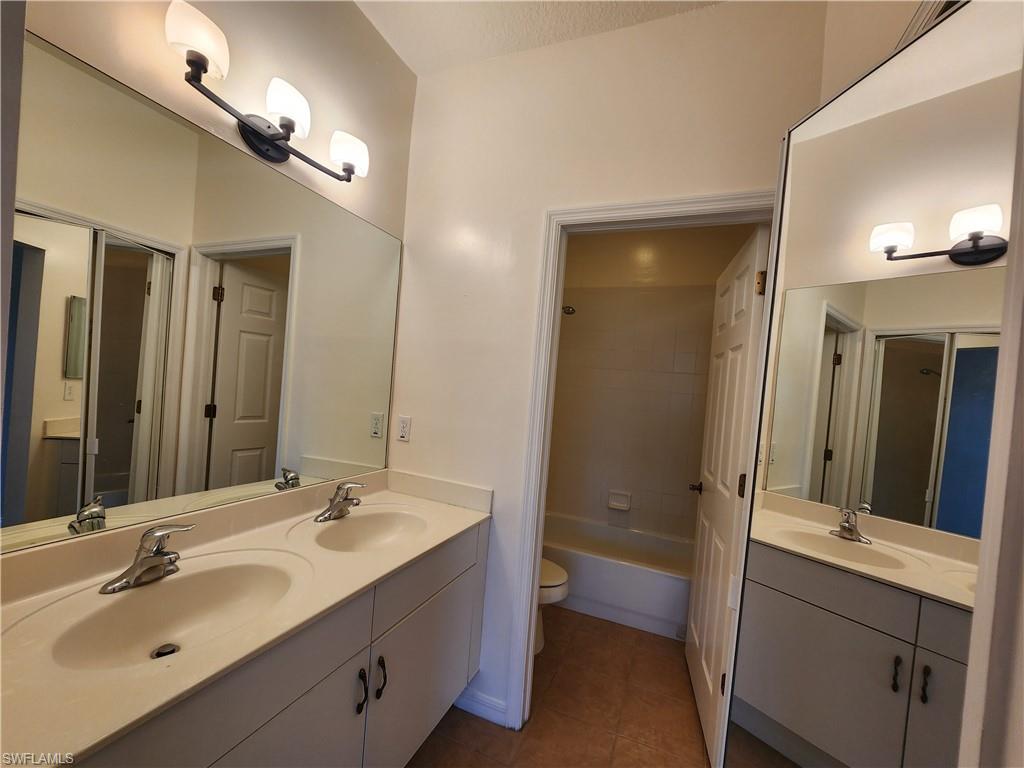 7512 Bristol Circle Naples, FL 34120 - Photo 9 of 22 a bathroom with a sink double vanity granite tub and shower