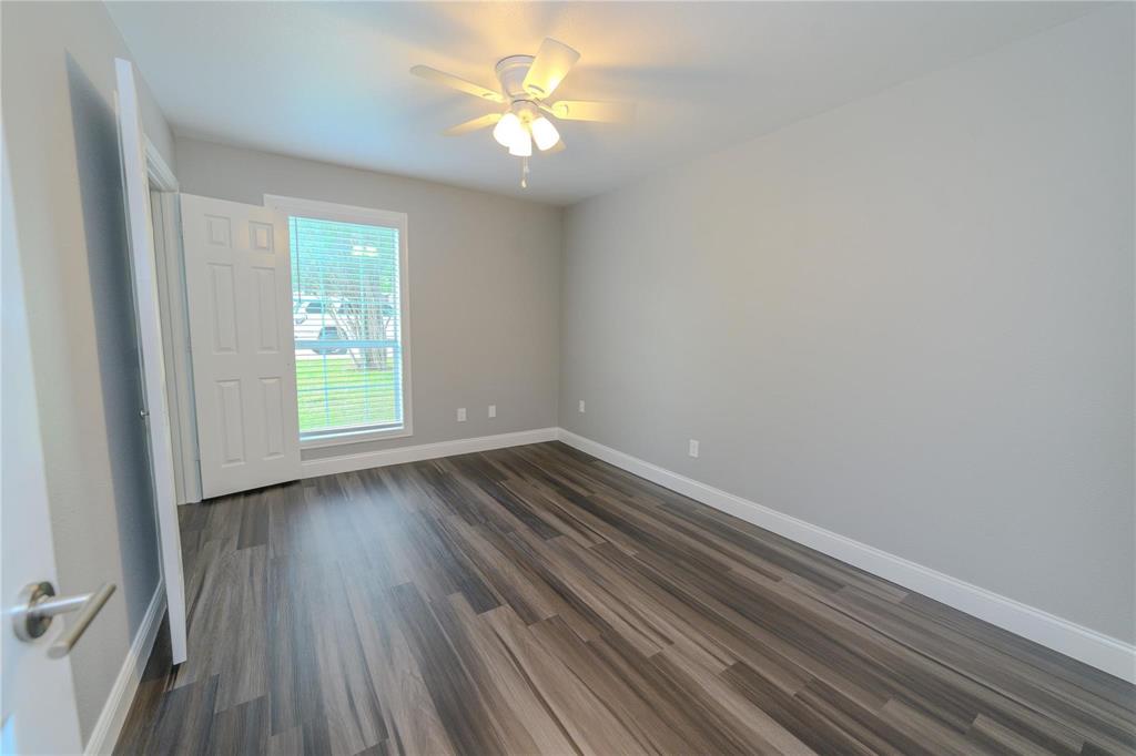 809 Wilcox Street McKinney, TX 75069 - Photo 15 of 26 Empty room with a ceiling fan and dark wood finished floors