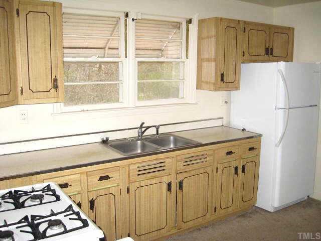 1334 Oberlin Road Raleigh, NC 27608 - Photo 4 of 12 a kitchen with stainless steel appliances granite countertop a sink and a refrigerator