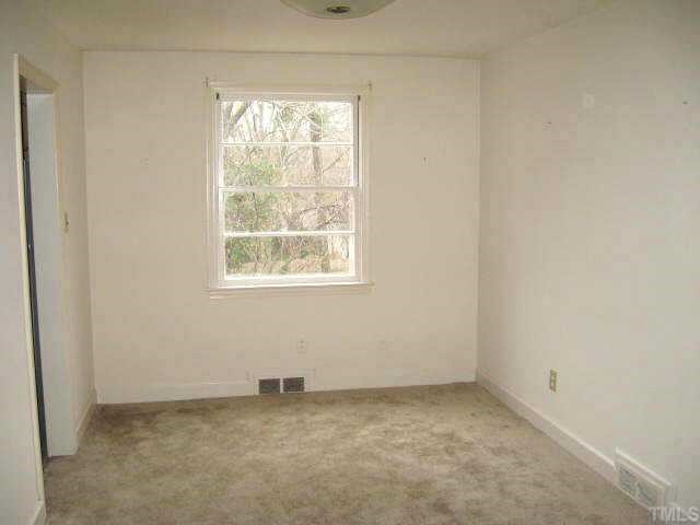1334 Oberlin Road Raleigh, NC 27608 - Photo 5 of 12 an empty room with a window