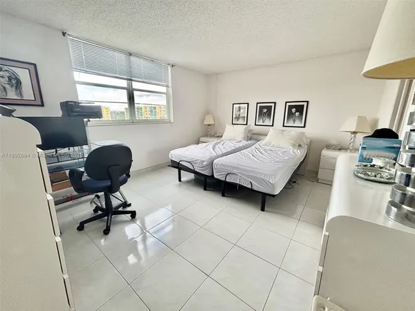 a bedroom with a bed and flat screen tv