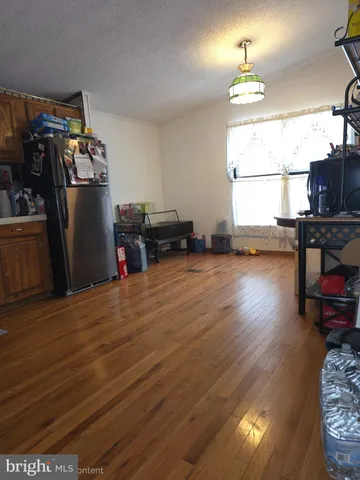 a view of a livingroom with furniture wooden floor and a window