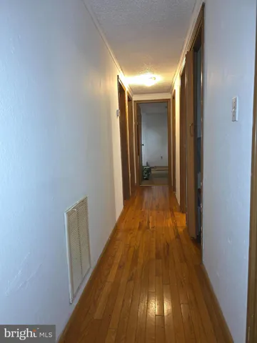 a view of hallway with wooden floor