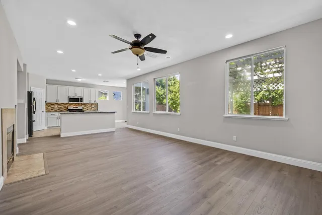 a view of a living room a window and wooden floor