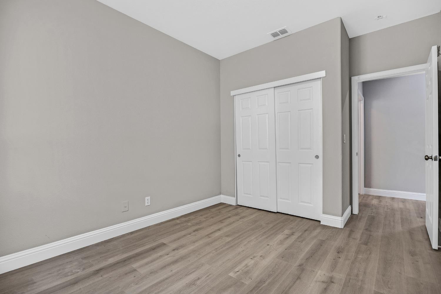 2963 Rugby Court Tracy, CA 95377 - Photo 17 of 40 a view of an empty room with wooden floor
