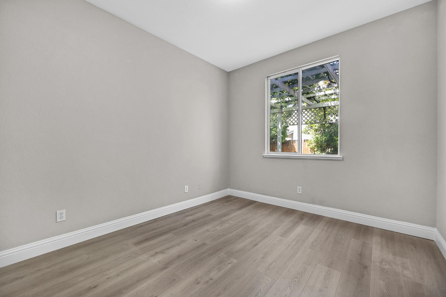2963 Rugby Court Tracy, CA 95377 - Photo 18 of 40 a view of an empty room with wooden floor and a window