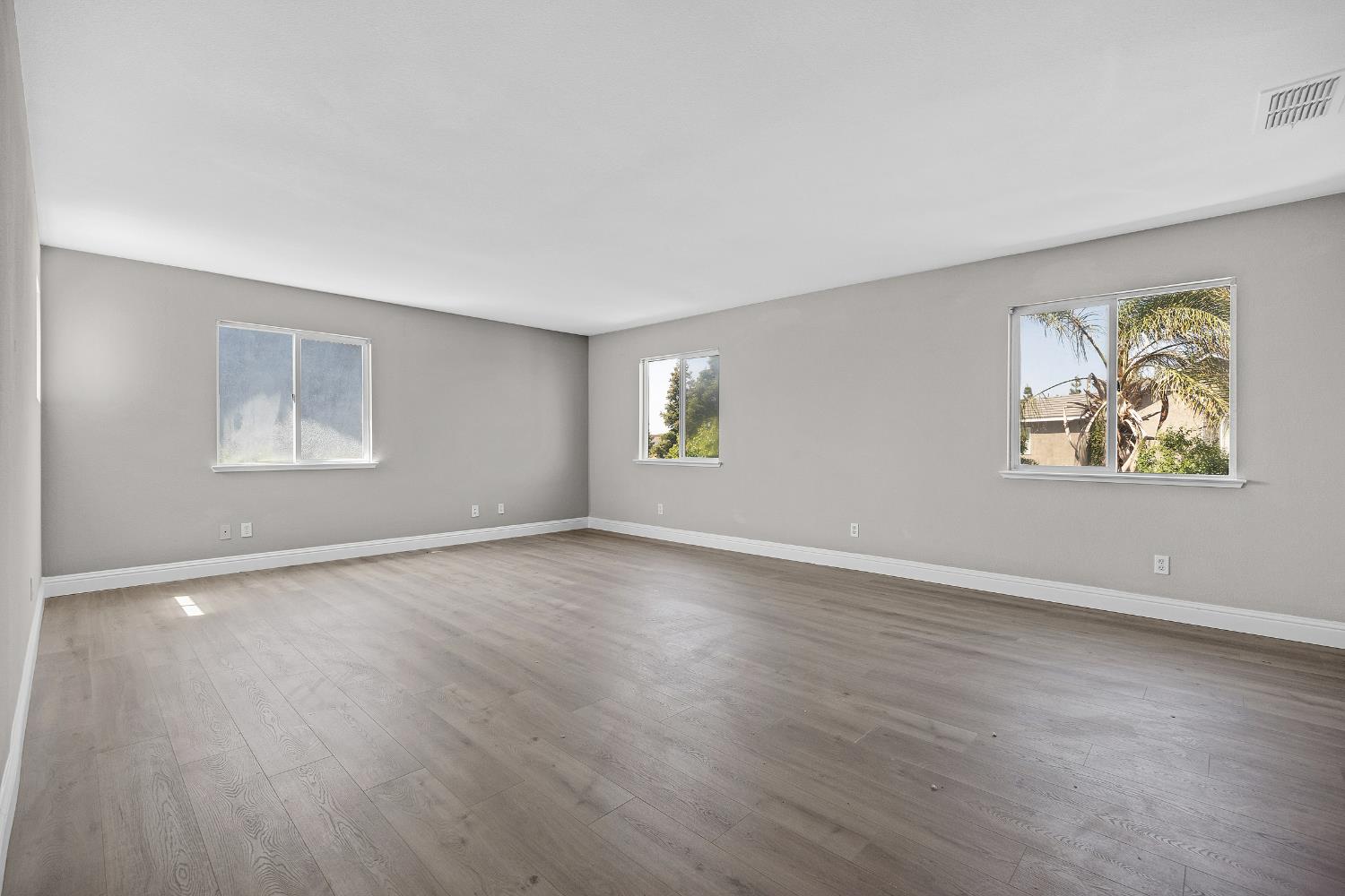 2963 Rugby Court Tracy, CA 95377 - Photo 21 of 40 a view of an empty room with a window and wooden floor