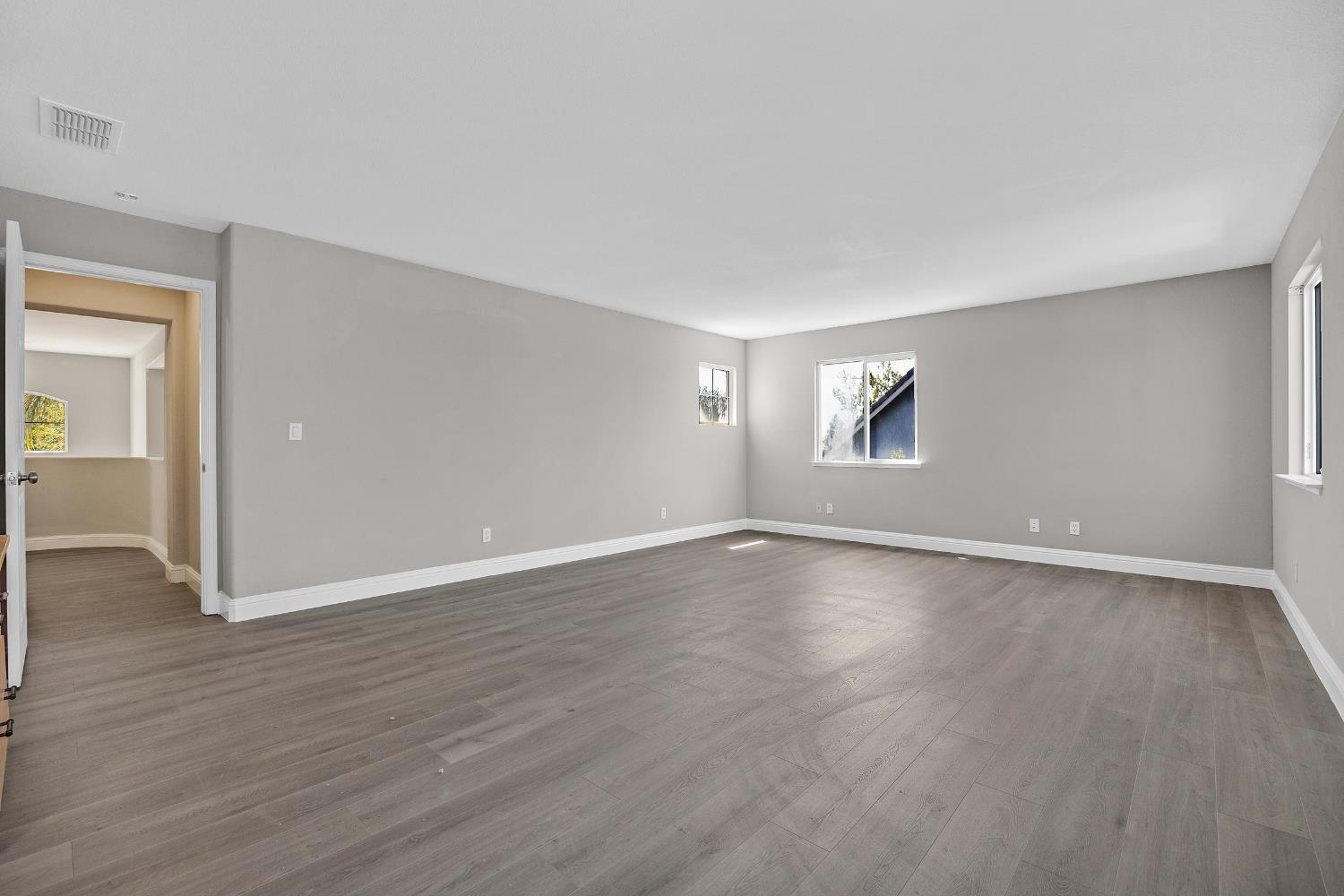 2963 Rugby Court Tracy, CA 95377 - Photo 23 of 40 a view of an empty room with wooden floor and window