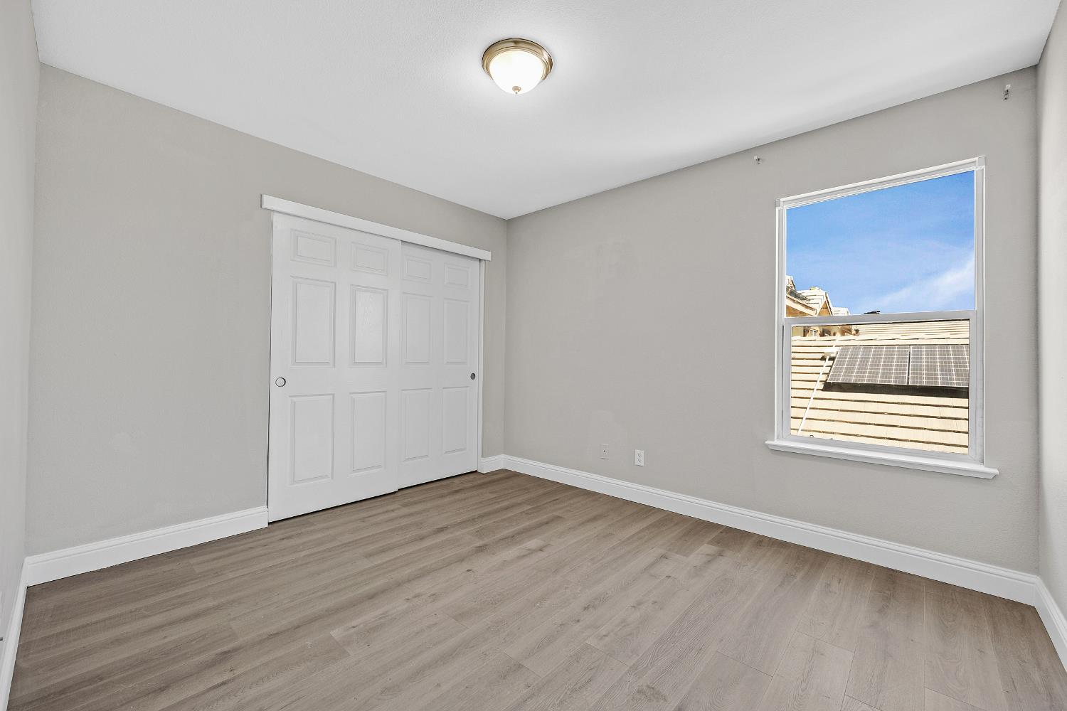 2963 Rugby Court Tracy, CA 95377 - Photo 29 of 40 a view of an empty room with wooden floor and a window