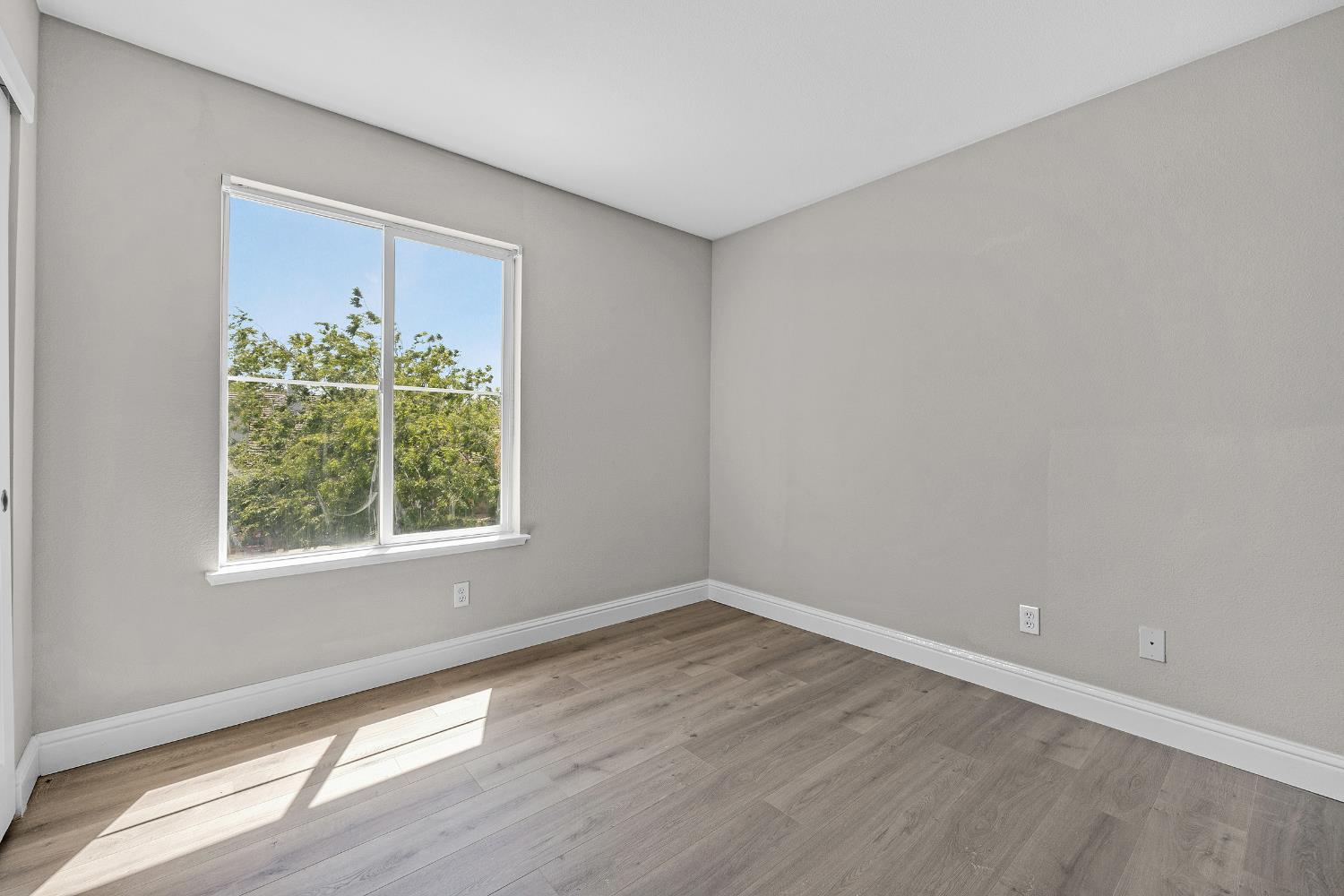 2963 Rugby Court Tracy, CA 95377 - Photo 31 of 40 a view of an empty room with wooden floor and a window