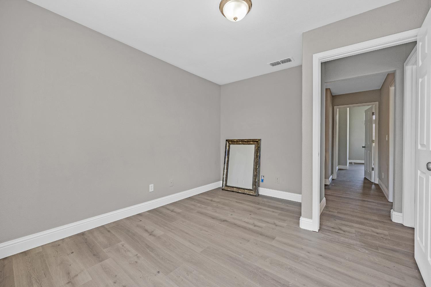 2963 Rugby Court Tracy, CA 95377 - Photo 32 of 40 a view of an empty room with wooden floor