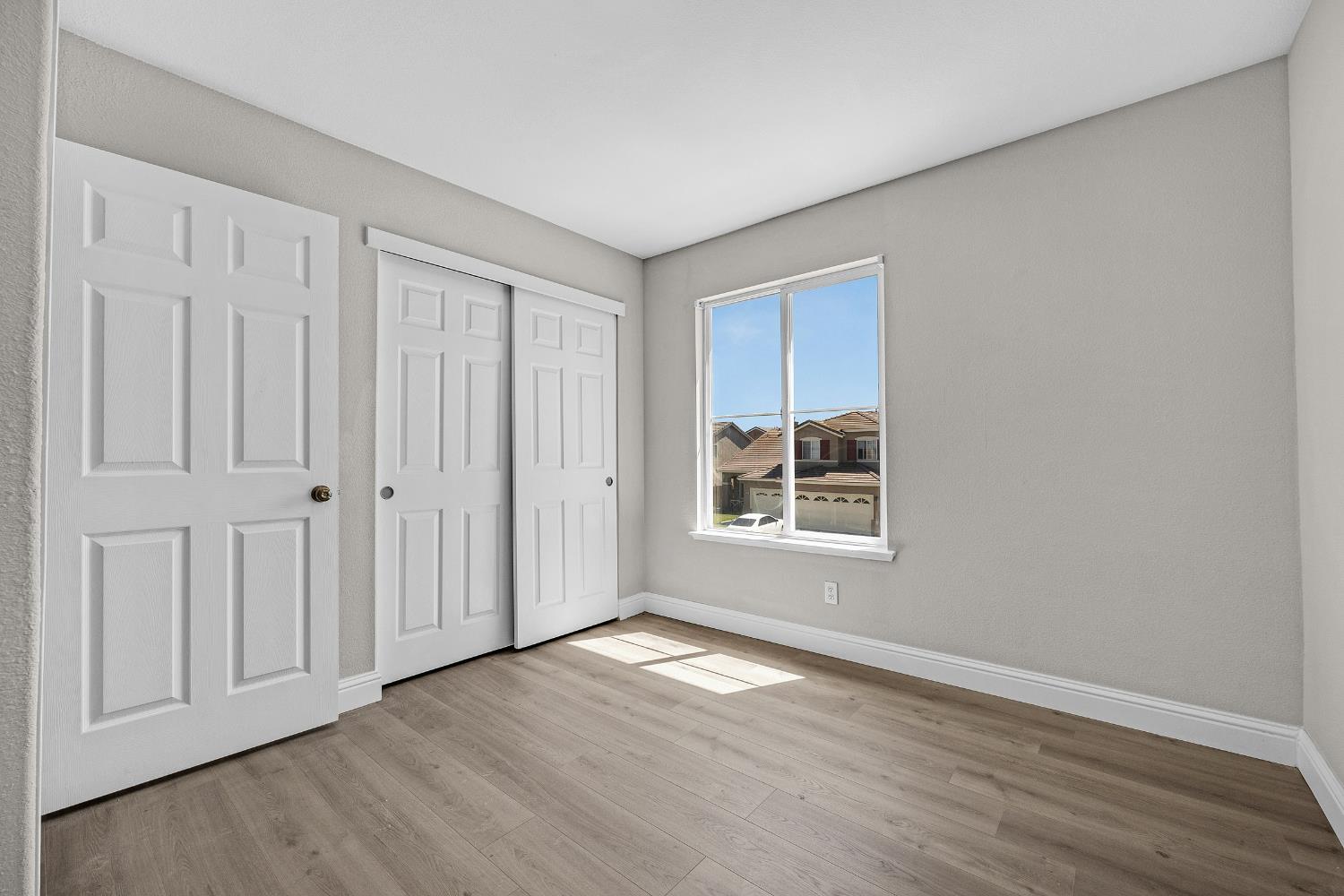 2963 Rugby Court Tracy, CA 95377 - Photo 33 of 40 a view of an empty room with wooden floor and a window