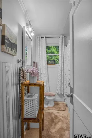 a view of bathroom with a bath tub and mirror