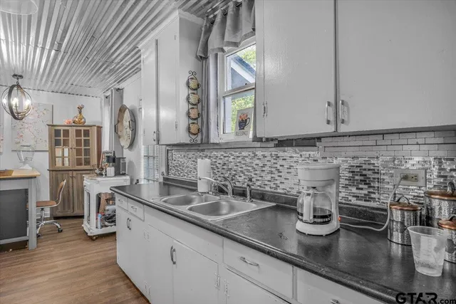 a kitchen with sink and cabinets