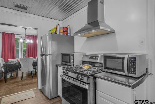 a kitchen with stainless steel appliances granite countertop a stove and a refrigerator