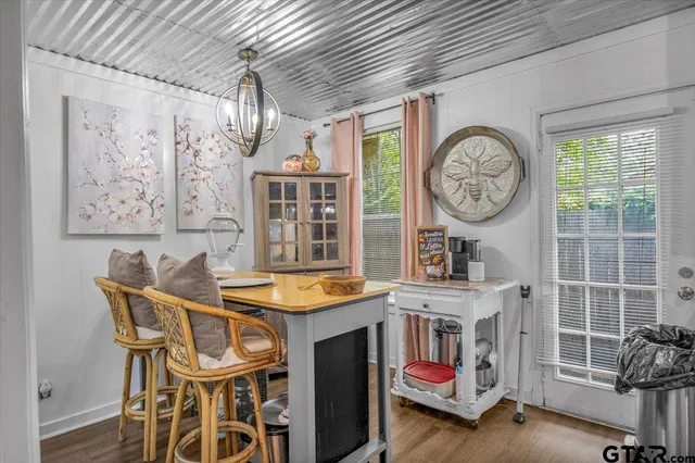a dining room with a wooden table and chairs